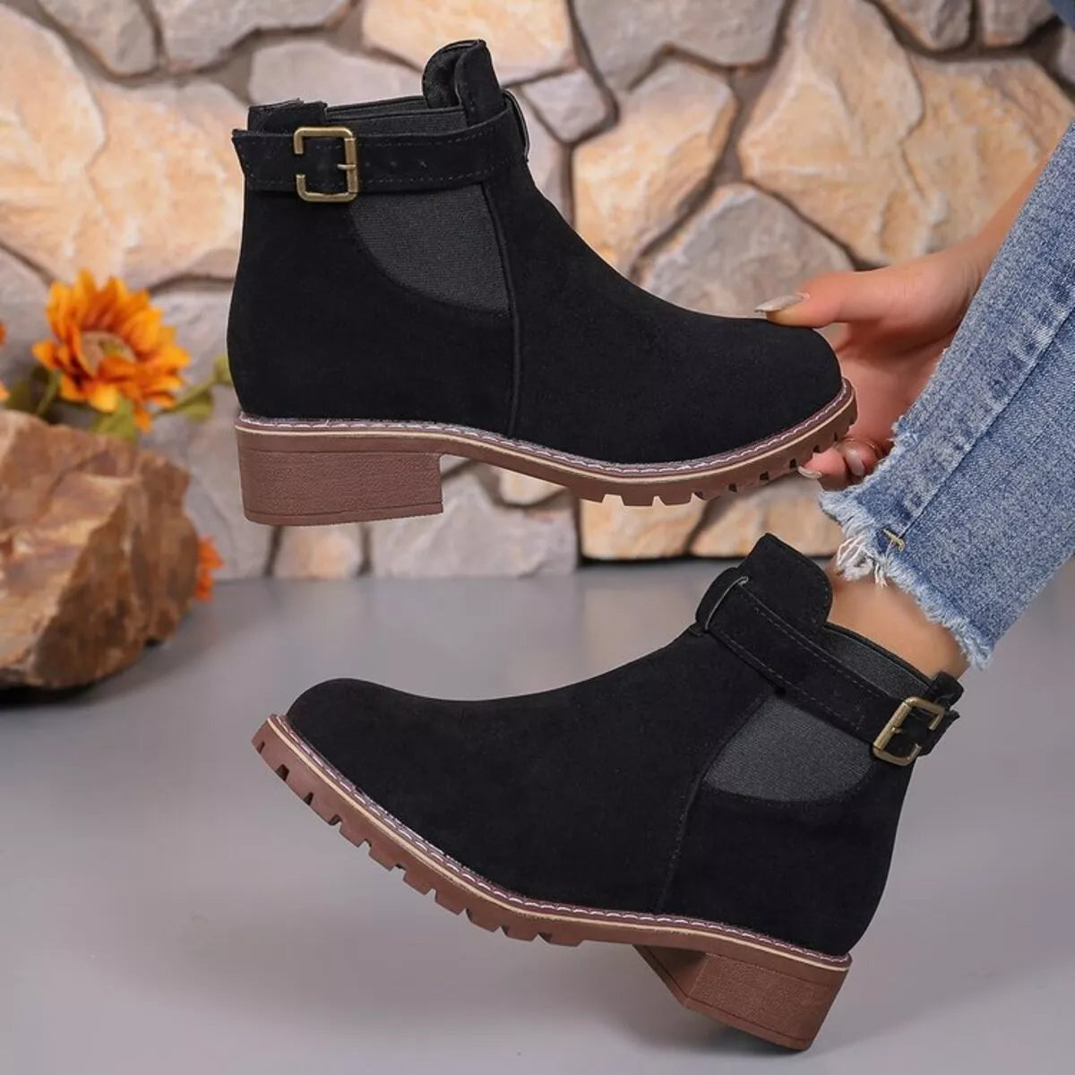The Round Boot, a round toe block heel ankle boot in black and camel, front view