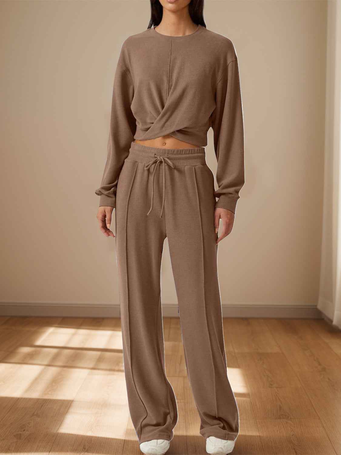 Woman wearing a matching crisscross top and drawstring pants set, a comfortable airport outfit for long flights
