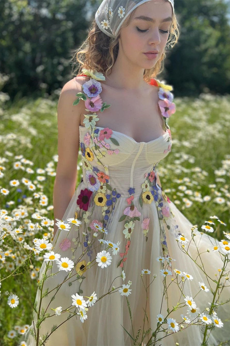 Woman in a floral dress standing in a field of flowers