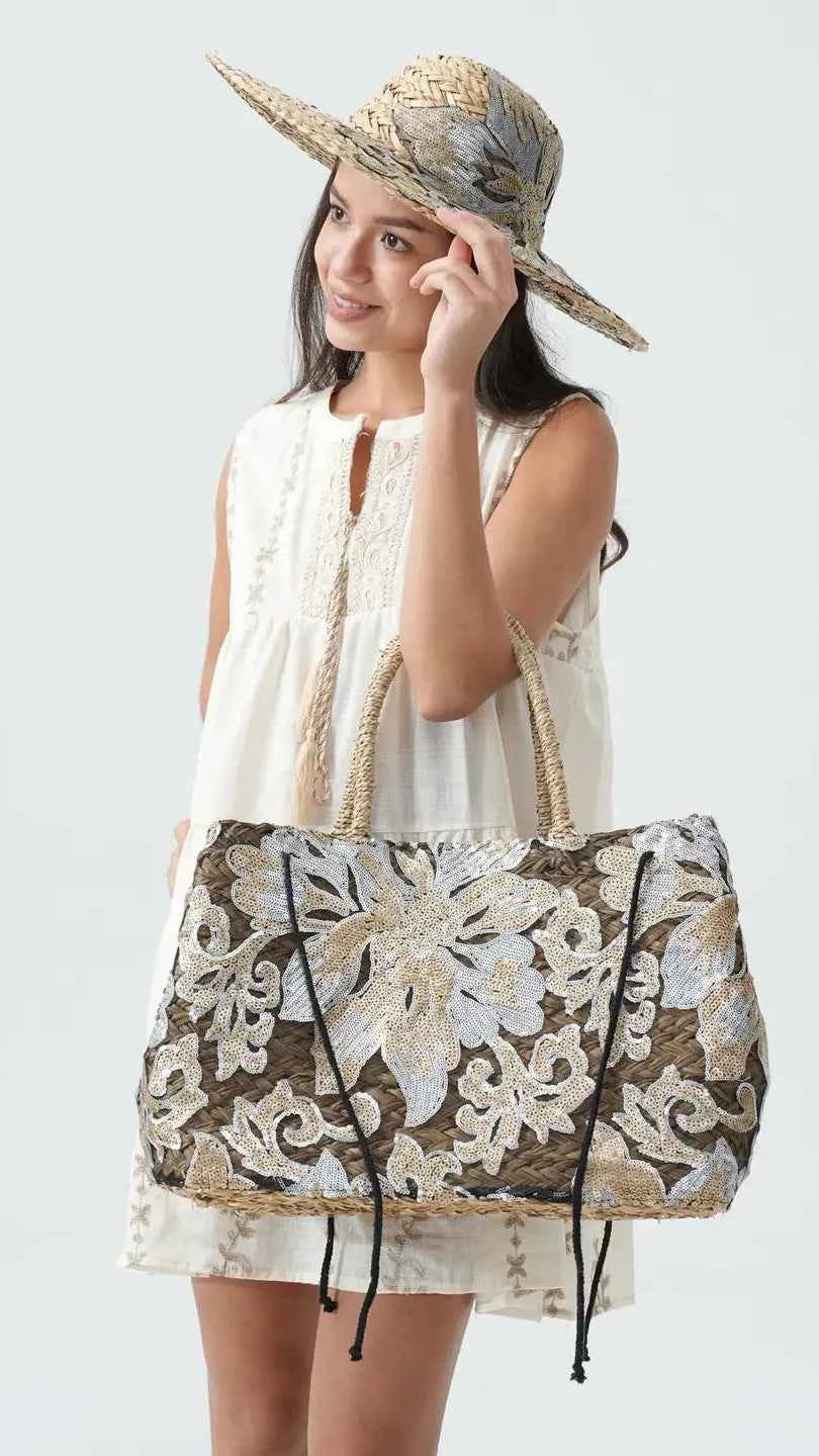 Woman holding a floral-patterned bag against a white background