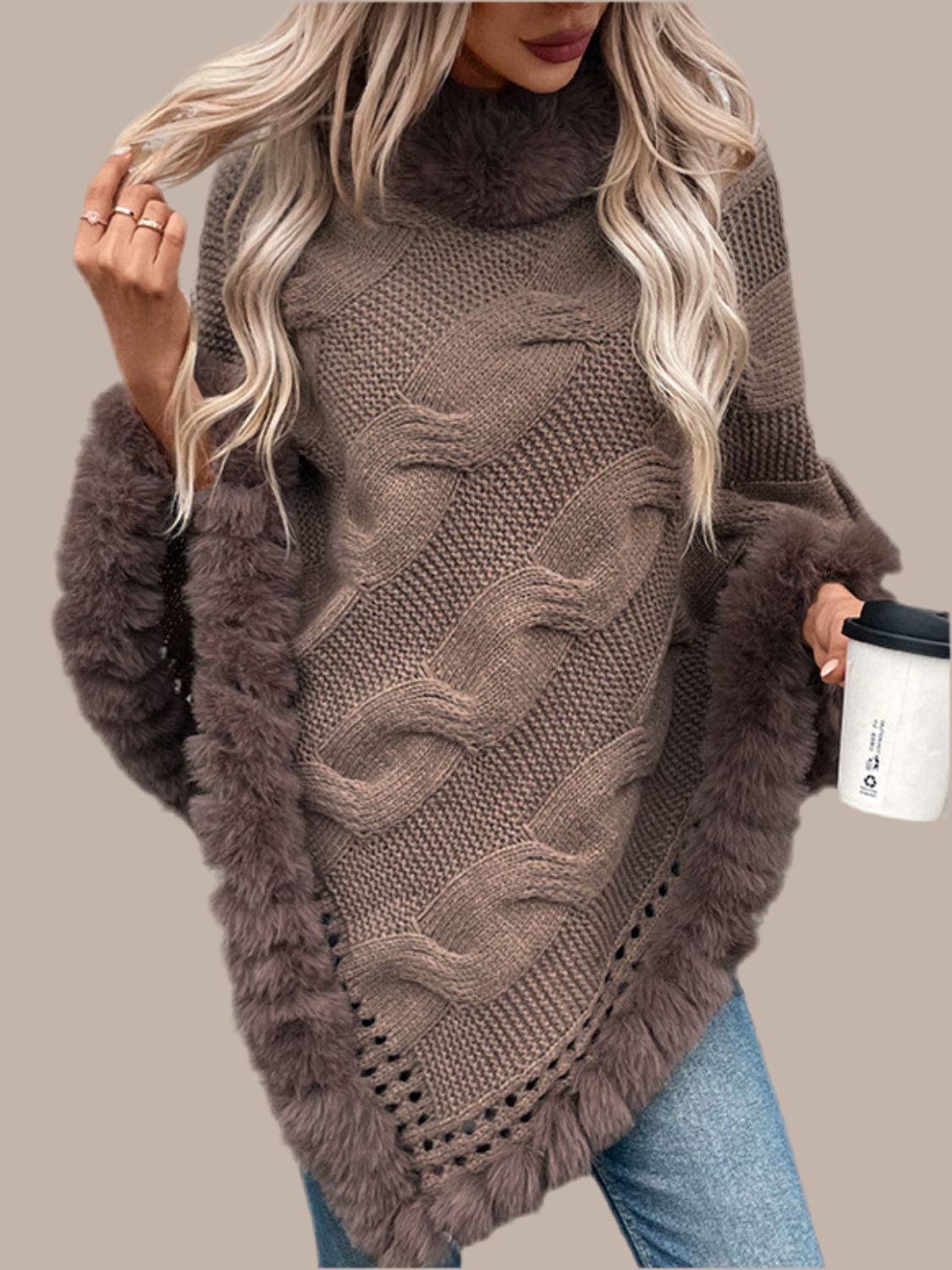 Woman wearing HOORR's Wrap-Up Poncho, a fuzzy-hem cable-knit poncho styled over jeans