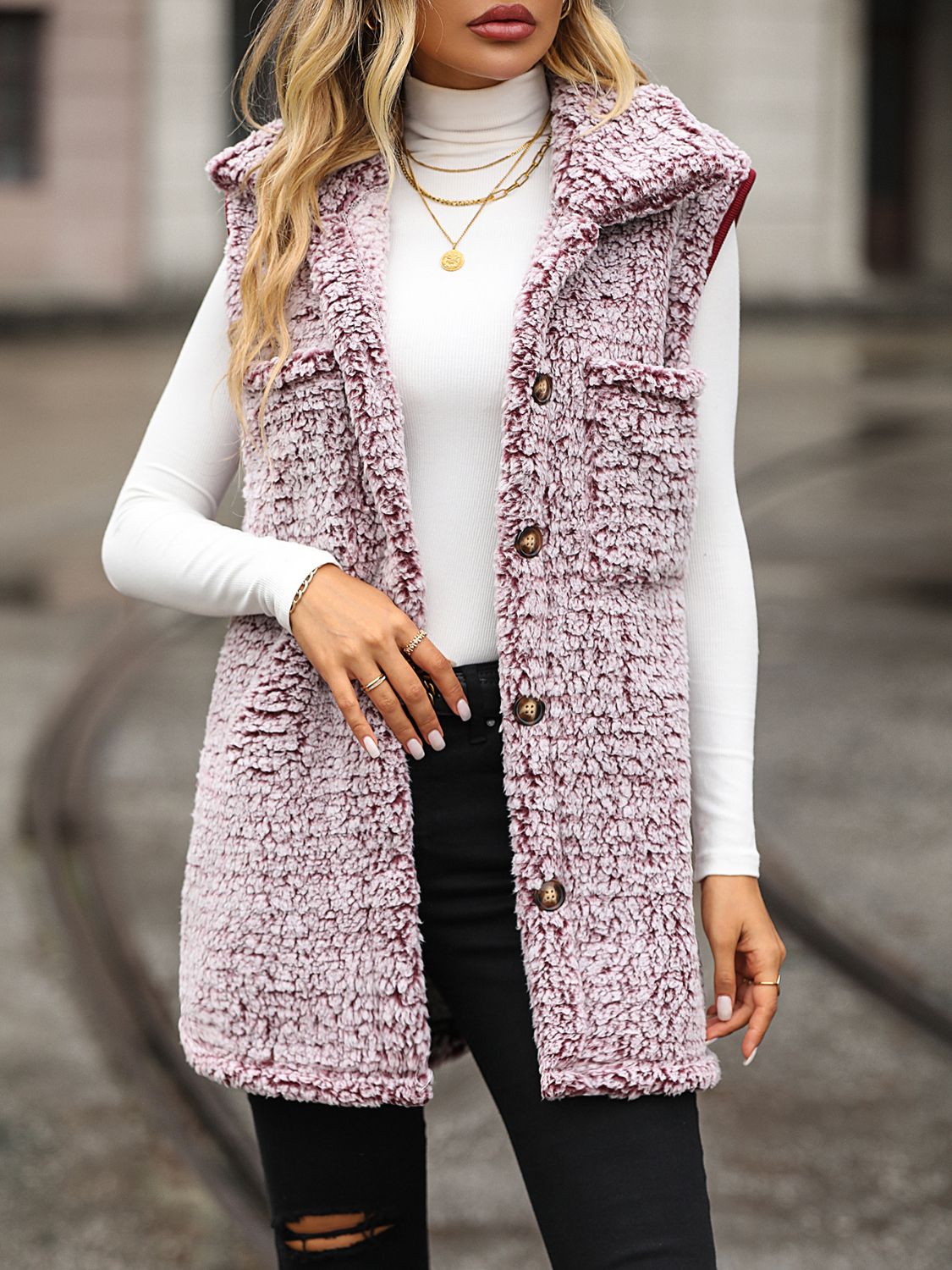 Woman wearing The Collared Vest, a button-down pocketed vest, layered over a top